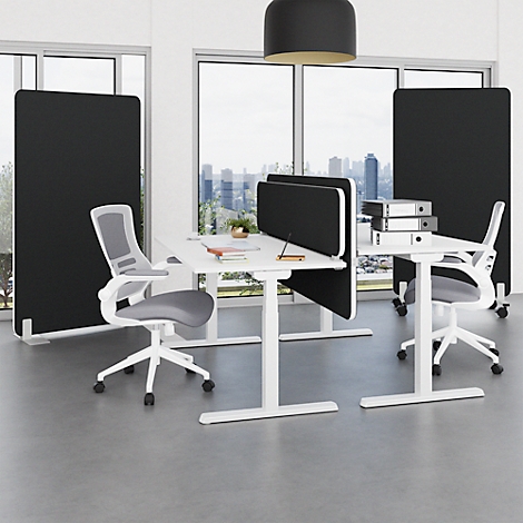 Office with white desks, partitions, and chairs; windows with city views.