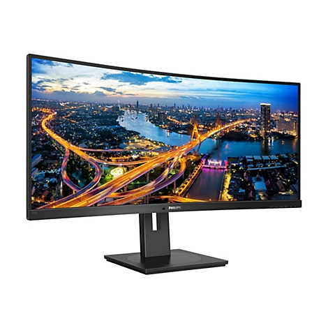 Curved Monitor, auf dem eine Nachtszene mit Brücken und Gebäuden dargestellt ist. Der Monitor hat einen schwarzen Rahmen und steht auf einem Ständer.