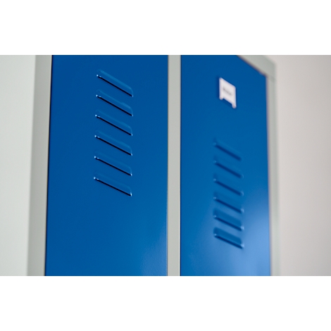 Blue painted cabinet doors with ventilation slots. A small white sign is on one door.