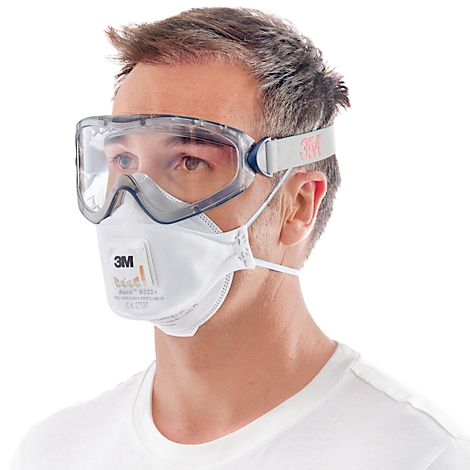 Ein Mann mit Schutzbrille und Atemschutzmaske von 3M, Blick geradeaus.