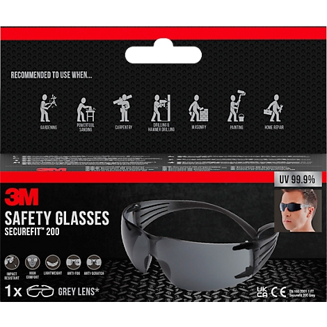 Graue Schutzbrille mit 3M Logo. Auf der Verpackung Piktogramme von Handwerkern. "UV 99,9%" und Logos.