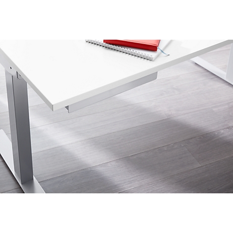 White desk with silver legs, notebook, and red book. Gray wooden floor.
