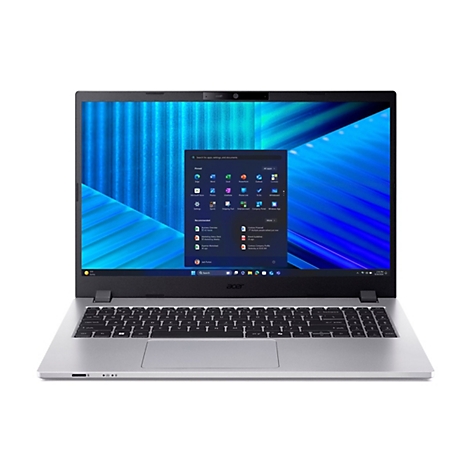 Ein silberner Laptop, der geöffnet auf einem Tisch steht. Der Bildschirm zeigt ein Windows-Startmenü mit App-Symbolen. Die Tastatur ist beleuchtet.