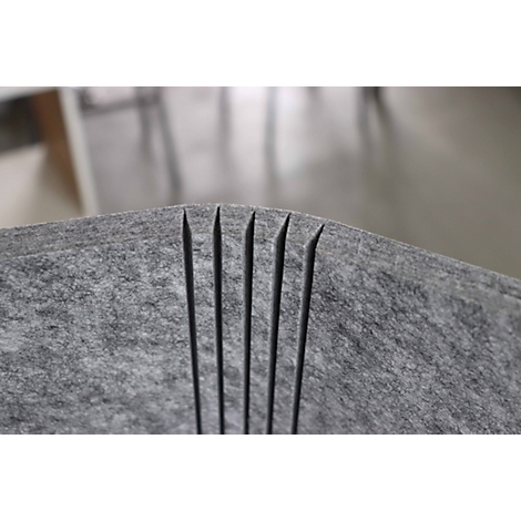 Grey felt material with six vertical cuts, forming thin strips.