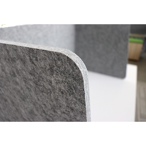 Close-up of a gray, rounded felt board. Other boards in the background.