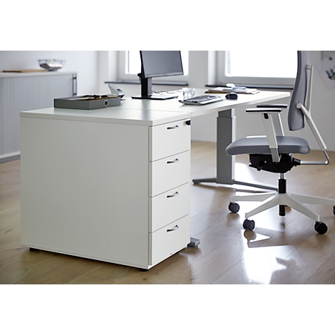 White office desk with four drawers. An office chair is next to it.