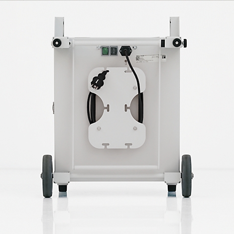 Back of a white medical device. Power cable and plug holder, two wheels at the bottom, two holders at the top.