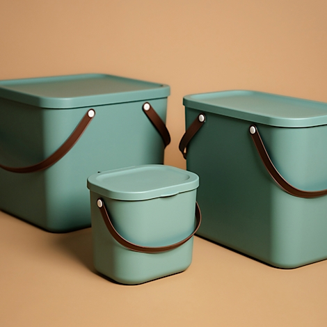 Three green square buckets with lids and brown handles against a beige background.