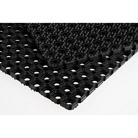 Dos alfombrillas de goma negras superpuestas con un patrón de agujeros cuadrados.