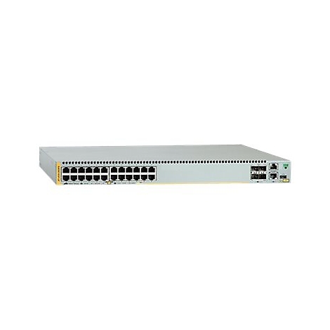 Ein grauer Netzwerkswitch mit mehreren Anschlüssen, vor weißem Hintergrund. Der Switch hat eine rechteckige Form mit schwarzen Anschlüssen und einer gelben Umrandung.