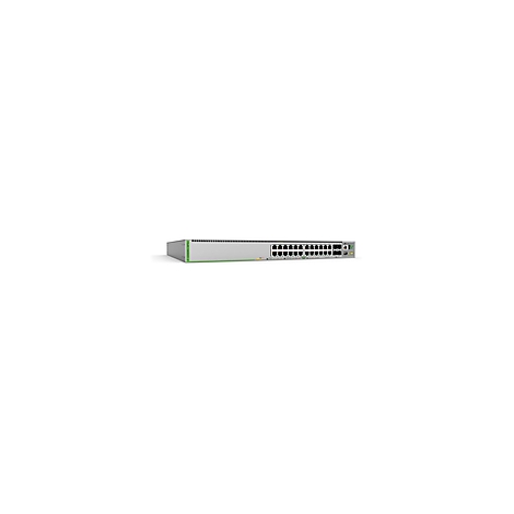 Ein silberner Netzwerk-Switch mit grünen Akzenten und zahlreichen Anschlüssen, die auf einer weißen Oberfläche angeordnet sind.