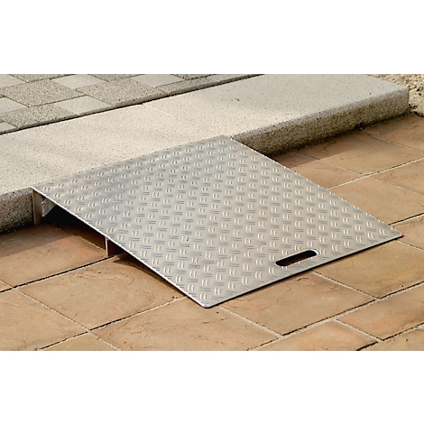 Silver ramp with checkered surface, overcoming a height difference. A handle is recessed.