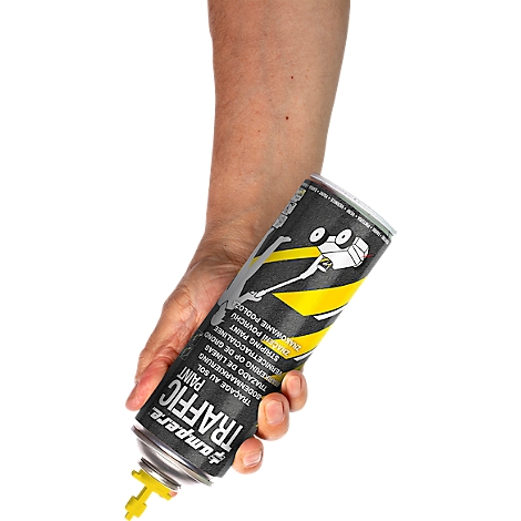 Person holds can of traffic paint, text: Traffic Paint. Yellow nozzle detail. On white background.