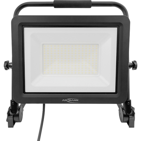 Black construction spotlight with white light, carrying handle, cable. Inscription: ANHMANN.