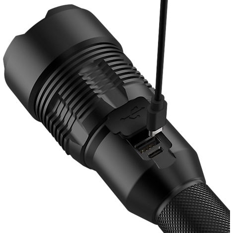 Black LED flashlight with USB port, being charged with a cable.