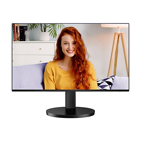 Ein schwarzer Monitor zeigt eine junge, rothaarige Frau, die lächelt. Sie trägt einen gelben Pullover. Im Hintergrund sind Wohnaccessoires zu sehen.