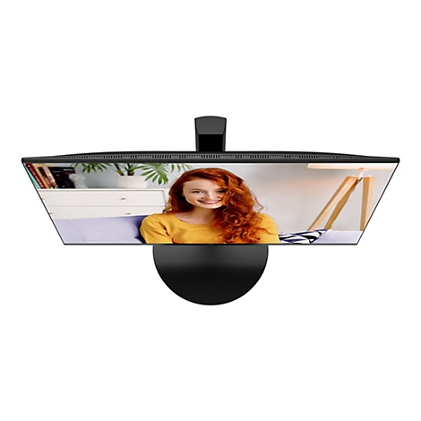 Der Blick von oben auf einen schwarzen Monitor, der eine lächelnde Frau mit roten Haaren zeigt.