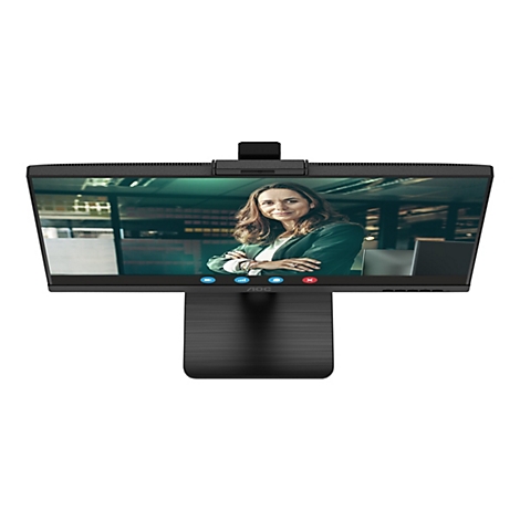 Der Monitor zeigt ein Videogespräch. Eine Frau in einem grünen Blazer schaut in die Kamera. Der Monitor hat einen schwarzen Rahmen und einen Standfuß.