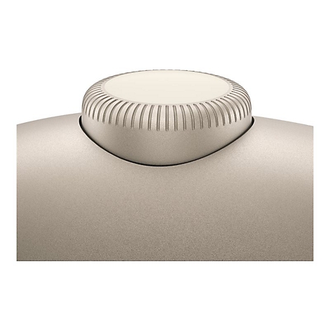 Nahaufnahme eines runden, geriffelten Einstellknopfes in hellem Beige auf einer glatten, körnigen Oberfläche.