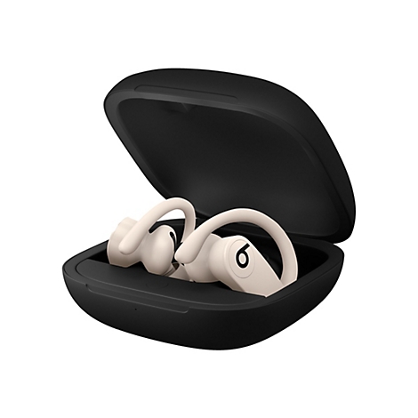 Écouteurs sans fil beiges dans un étui de chargement noir ouvert. Un écouteur porte un "6" blanc.