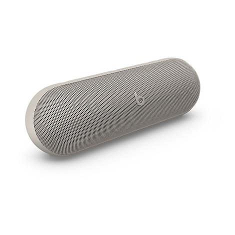 Beige Beats Pill Bluetooth-Lautsprecher in länglicher Kapselform vor weißem Hintergrund.
