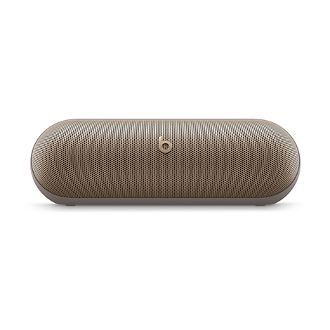 Haut-parleur Bluetooth ovale de couleur or sur fond blanc. Le haut-parleur a de petits trous et le logo Beats.