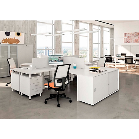Modern office with desks, chairs, and computers. Large windows, bright lighting.