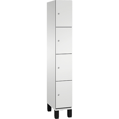 Armoire blanche avec quatre tiroirs, pieds noirs et petites poignées.