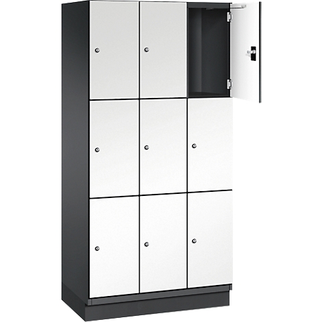 Armoire avec portes blanches, dont une ouverte. Boîtier gris. Poignées en métal. Joints noirs.