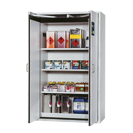 Armoire blanche avec portes ouvertes, remplie de pots de peinture, de bidons et de conteneurs de marchandises dangereuses. Des symboles d'avertissement sont clairement visibles sur les conteneurs.
