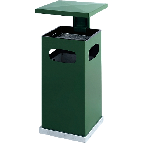 Green square trash can with lid, with cutouts. Standing on a concrete base.