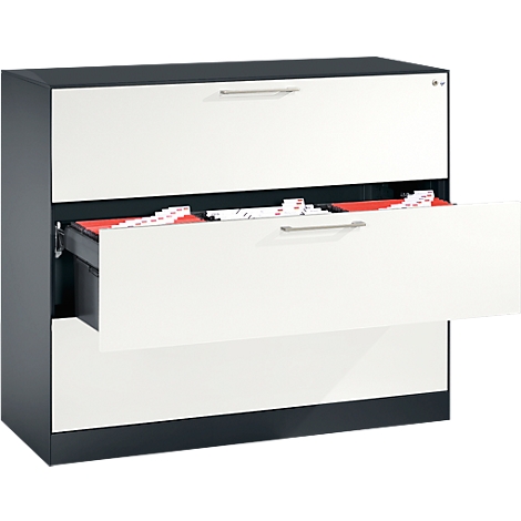 White filing cabinet with three drawers, one open, revealing red folders. Black body, silver handles.