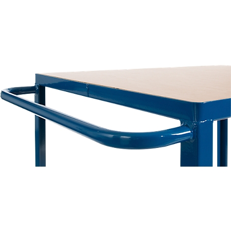 Close-up of a blue handle on a table. The table has a light wood top.
