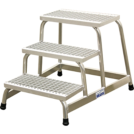 Silver stepladder with three steps and a grid pattern. Black rubber feet, the name "KRAUSE" is visible on the side.