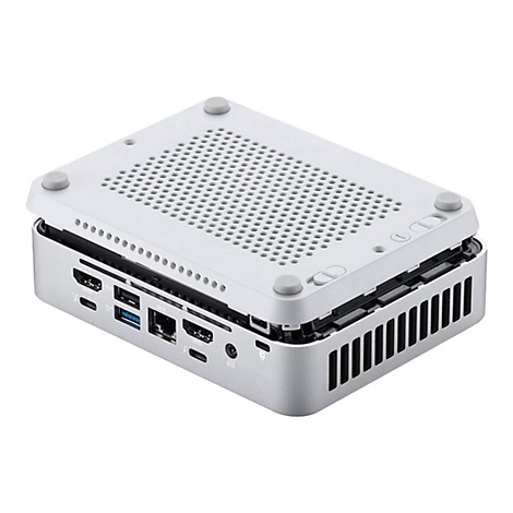 Silberfarbener Mini-PC, Deckel halb geöffnet, zeigt Anschlüsse. Grauer Deckel mit Lochmuster. Details: HDMI, USB, Ethernet.