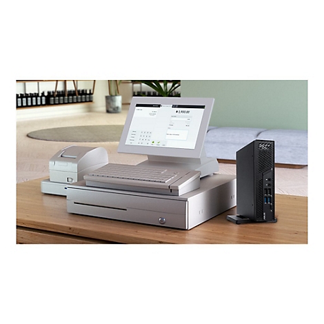 Ein Kassensystem mit Monitor, Tastatur und Drucker, daneben ein schwarzer PC.
