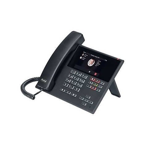 Schwarzes Tischtelefon mit Farbdisplay und Tastatur vor neutralem Hintergrund.