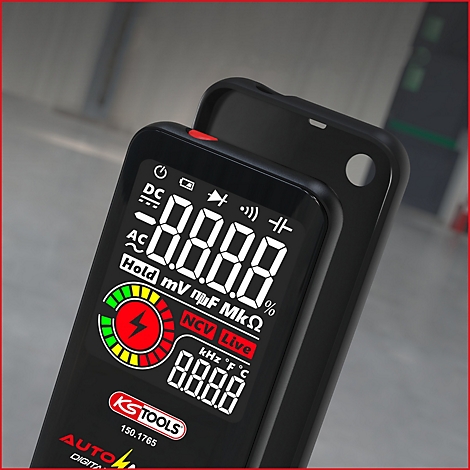 Digitales Multimeter mit Display, schwarzem Gehäuse und rotem Rahmen. Anzeige mit Zahlen, Schriftzügen und einem Warnsymbol.
