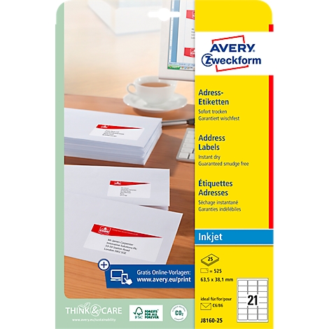 Close-up of envelopes with address labels, next to it an Avery Zweckform label pack. A cup of coffee on the table.