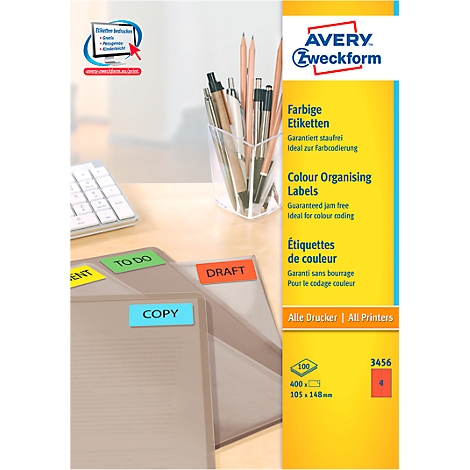Office scene with yellow, green, blue and red labels on folders. In the background pens and a pen holder.