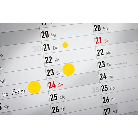Close-up van een kalender met markeringen. Gele cirkels markeren datums. De 24e is rood gemarkeerd. Peter staat in de hoek.