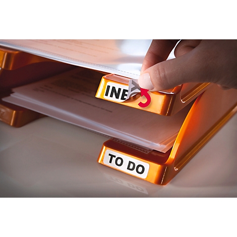 Person is sticking on an index sticker. The folder says "To Do".