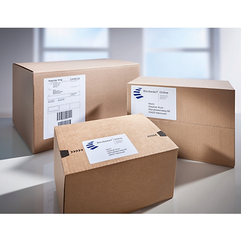 Drie bruine verzenddozen met etiketten. De voorste doos heeft een barcode-etiket.