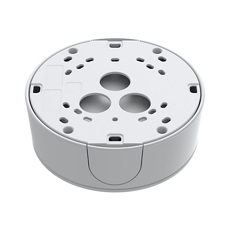 Appareil cylindrique gris clair, dessous avec trous et évidements ronds.