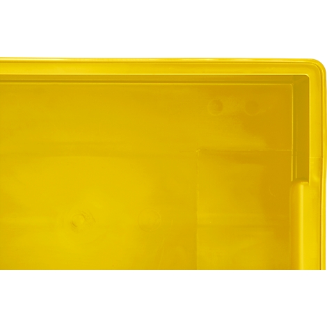 Surface en plastique jaune d'une boîte avec un coin et un bord arrondis.