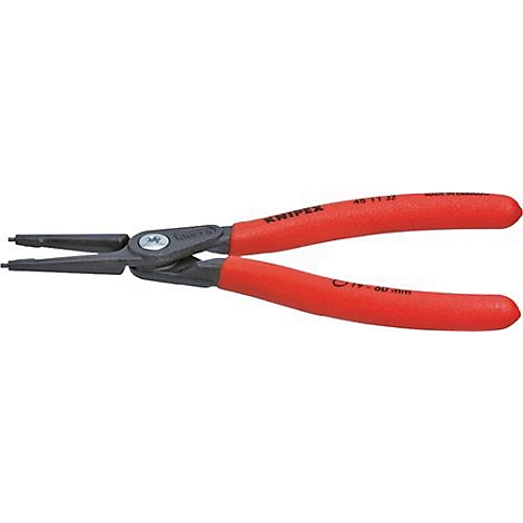 Gros plan sur une pince avec des poignées rouges et une tête noire. Le nom de la marque KNIPEX est visible.
