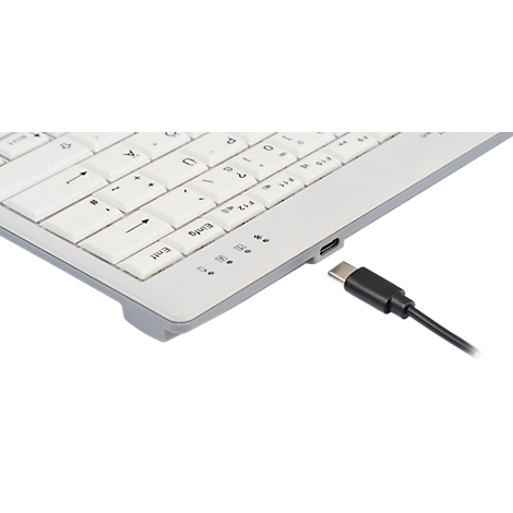Graue Tastatur mit weißen Tasten, blau hervorgehobenen Buchstaben, Buchstaben und Ziffern. Das Logo von Becker Electronics ist sichtbar.