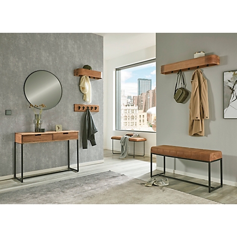 Banc beige avec assise côtelée et cadre en métal noir.