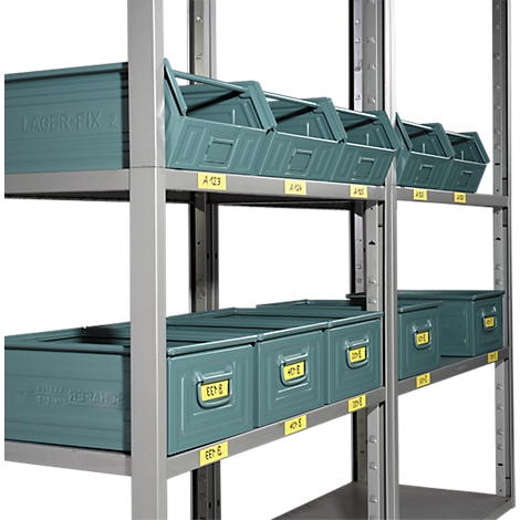 Rayonnage avec des bacs de stockage verts. Des étiquettes jaunes avec des combinaisons de lettres et de chiffres sont visibles sur les bacs et les rayonnages.