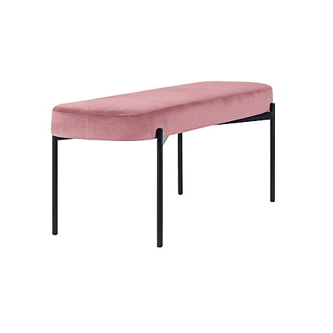 Roze fluwelen bank op zwart metalen frame. Afgeronde vorm, minimalistisch design.